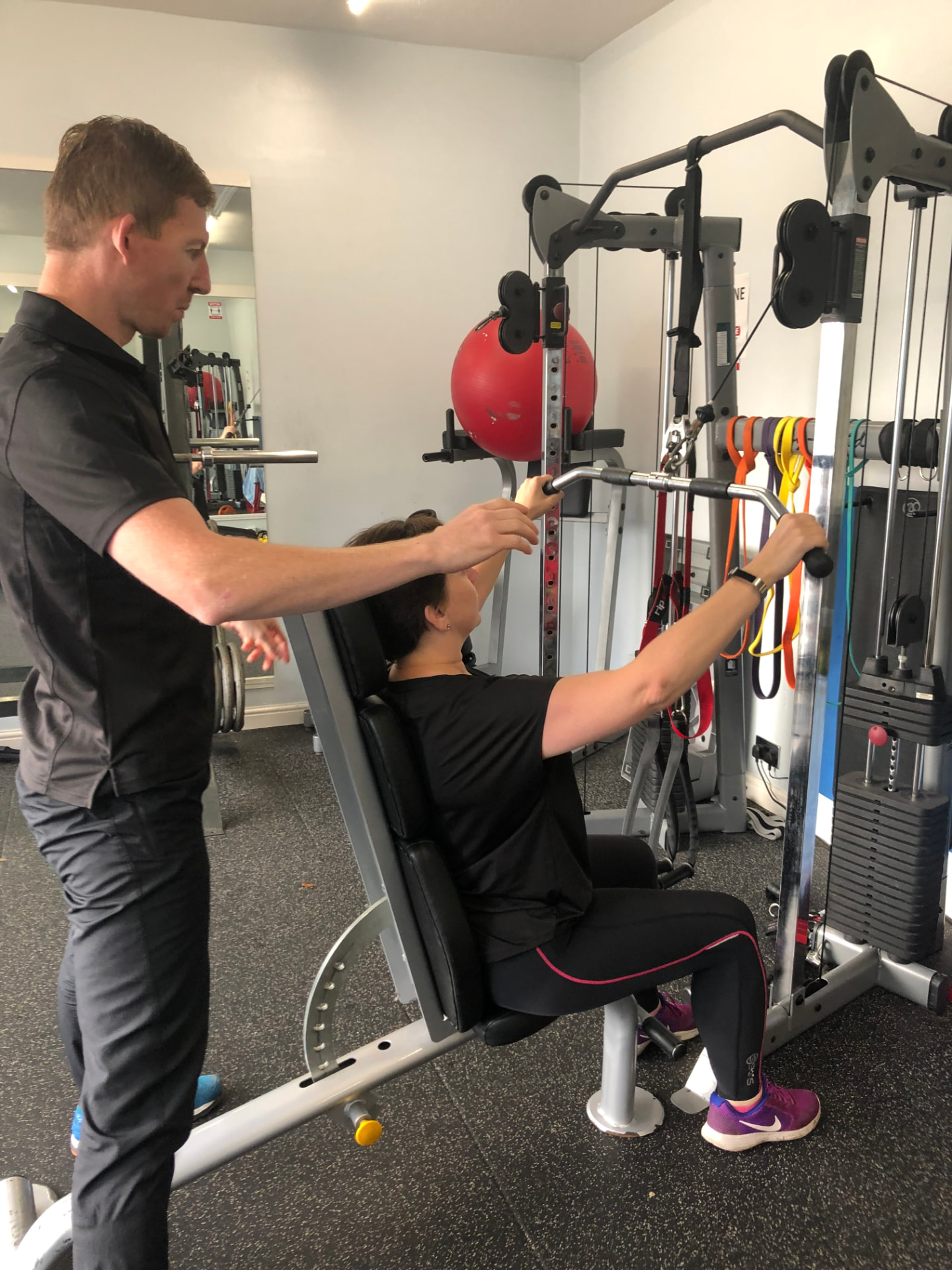 Mathew coaching a client through an exercise in the private studio